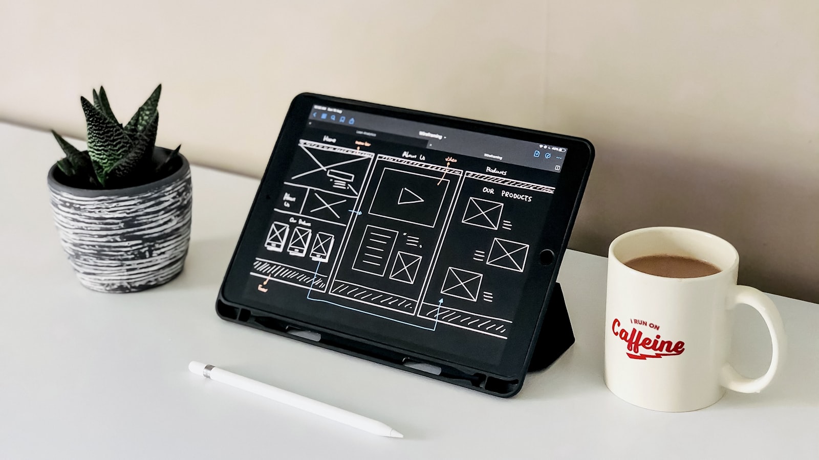 A minimal design workspace with a tablet on a clean desk